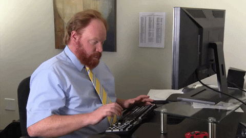 Man pressing key on keyboard GIF